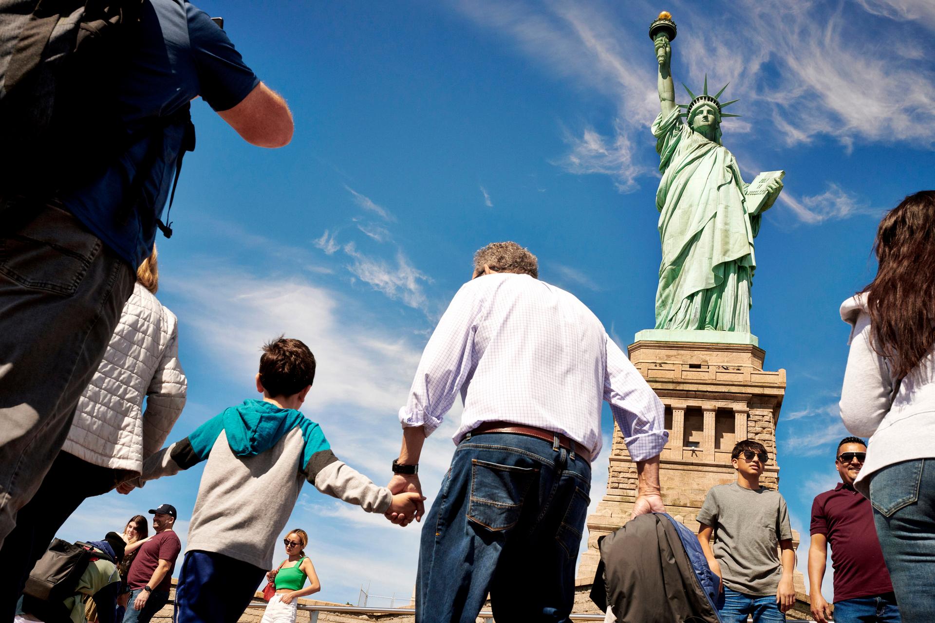 People walking around near Statue of Liberty